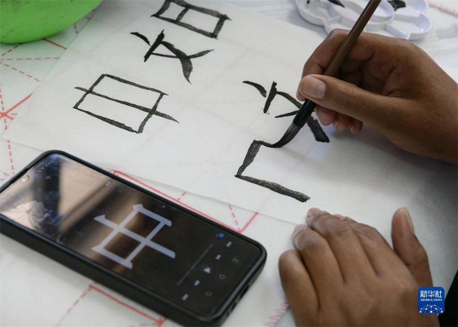 4月18日，肯尼亞學生在內羅畢大學孔子學院舉辦的活動上寫毛筆字。肯尼亞內羅畢大學孔子學院18日舉辦“中文，增進文明對話”主題活動，慶祝即將到來的第14個聯(lián)合國中文日?？夏醽唽W生參與互動，進行書法、剪紙、唱中文歌等活動。新華社記者 韓旭 攝
