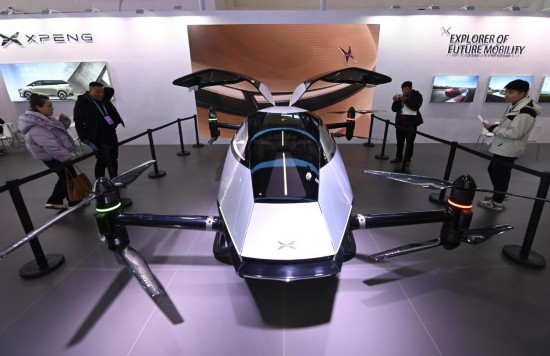 2023年12月1日，在鏈博會智能汽車鏈展區(qū)小鵬汽車展臺，參觀者觀看一臺智能飛行器。新華社記者蔡湘鑫攝