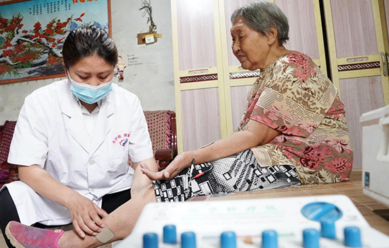 護(hù)理團(tuán)隊(duì)醫(yī)生為老人進(jìn)行低頻功能康復(fù)。陳佳兵攝