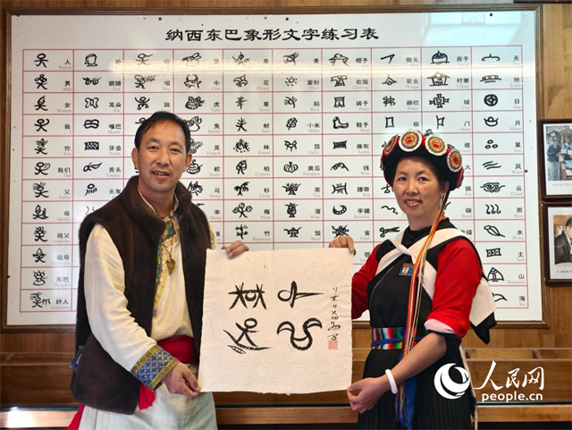 人民網(wǎng)“行進(jìn)中國”云南調(diào)研采訪團(tuán)走進(jìn)麗江，和閏元現(xiàn)場用東巴文寫下“行進(jìn)中國”。人民網(wǎng)記者 符皓攝