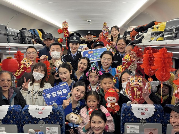 春節(jié)期間，在中老鐵路磨萬（磨丁—萬象）段，鐵路客運員工與乘客合影留念。李加勇攝