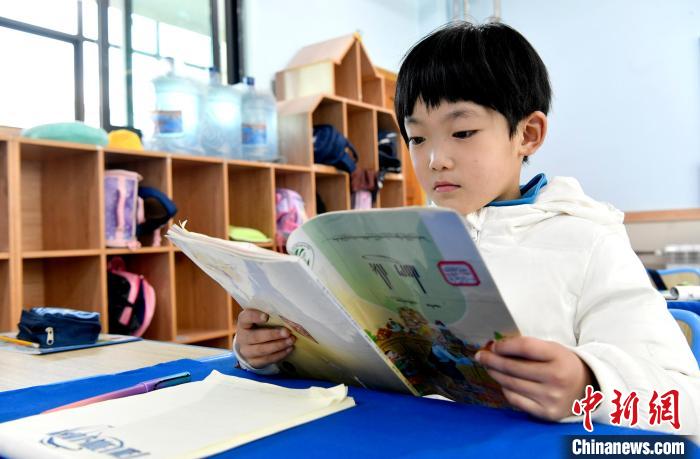 3月14日，西藏拉薩市第一小學(xué)一年級(jí)六班學(xué)生丁增樂吉在閱讀藏語(yǔ)課本?！±盍?攝